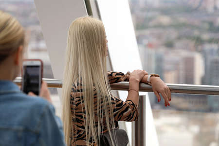 London, UK, May 29, 2019: Woman Photographing A Blonde Woman With Her Smartphone, Aerial view From Skyscraper In London, United Kingdom, Europeのeditorial素材