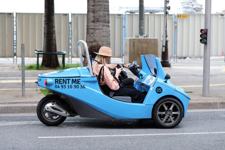 Nice, France - May 21, 2019: Young Couple Of Tourists In Small Blue Rental Car From NiceCar, Funny...