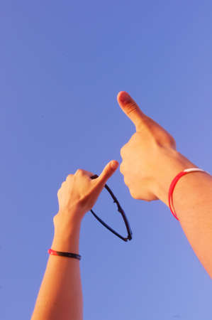 hand on the sky background. Hands showの写真素材