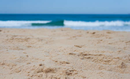 Close up of sand at the beach with waves breakingの写真素材