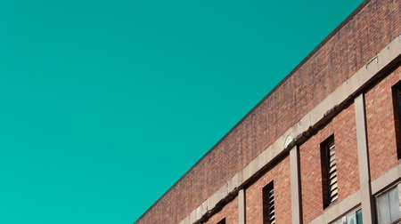 Straight line roofline against aqua skyの写真素材