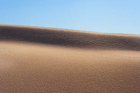 Dune edge closeup against clear blue skyの写真素材