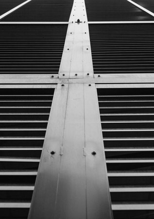 Low angle shot of metal grill on side of building.