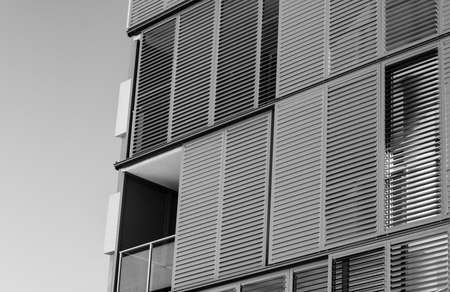 Shutters on apartment building against a clear sunny skyの写真素材