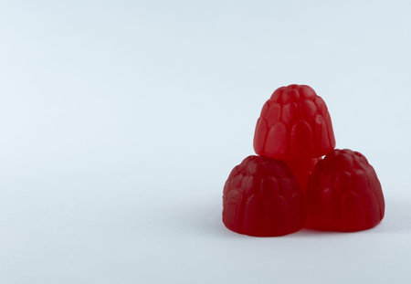 Raspberry pyramid on white background with copy space on left