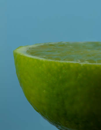 Lime half closeup on blue backgroundの写真素材