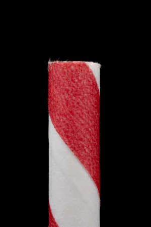 Macro landscape layout of two red and white paper straws on a black backgroundの写真素材