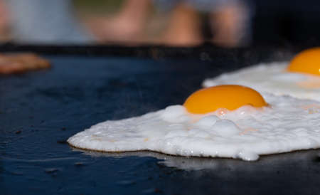 Closeup image of a cooking eggs on a barbecue at a school fundraiser on election day in Australiaの写真素材