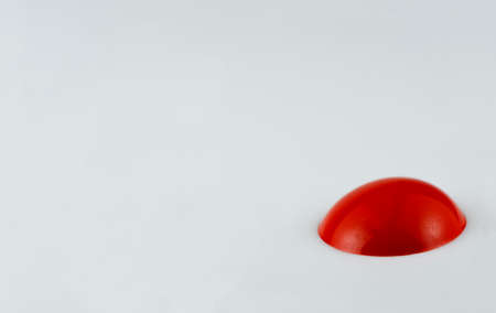 Close up of red blob of paint on white backgroundの写真素材