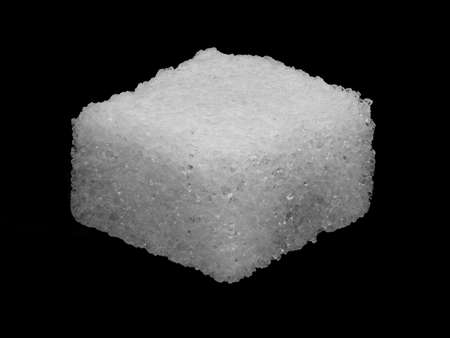 Macro image of a sugar cube isolated on a black backgroundの写真素材