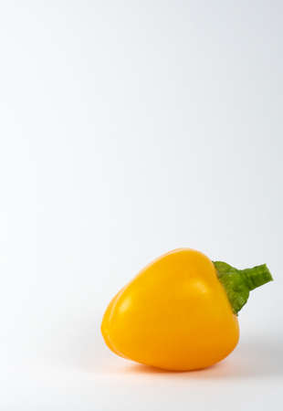 Closeup image of a yellow capsicum on a white backgroundの写真素材