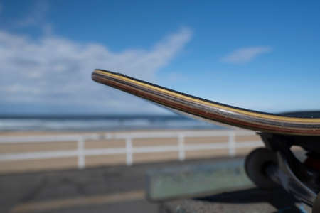 Close up of skateboard on top of a ramp at a beachside skate park.の写真素材