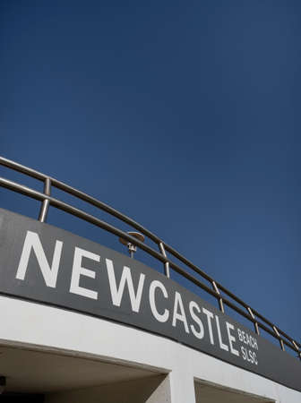 NEWCASTLE, AUSTRALIA - Jule 10  2019 Newcastle Beach Surf Lifesaving Club exterior against a clear blue skyのeditorial素材