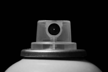 Top of a spray paint can isolated against a black backgroundの写真素材