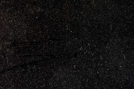 Macro image of the dust flecks on a black metal surfaceの写真素材