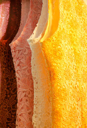 multicolored new lace dress hanging in row on saleの写真素材
