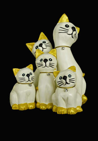 Group of carved wooden cats isolated on white backgroundの写真素材