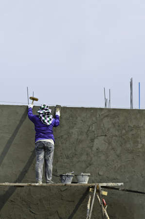 Mature contractor plasterer working outdoorsの写真素材