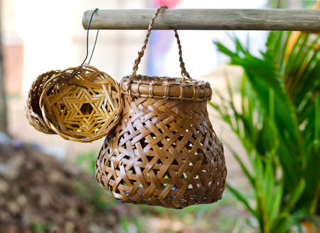 Handmade wicker baskets hanging on rodの写真素材