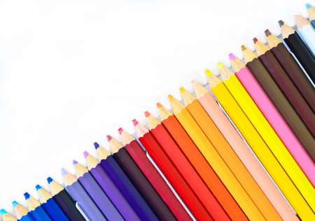 colored pencils in paper tray on white backgroundの写真素材