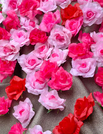 Artificial rose flower on glitter textureの写真素材