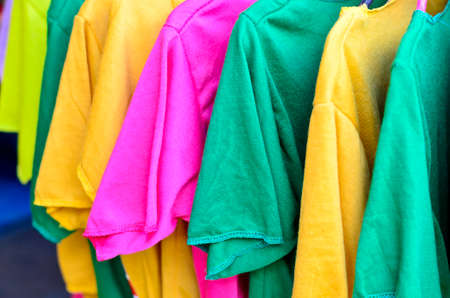 Colorful t-shirt on hangersの写真素材