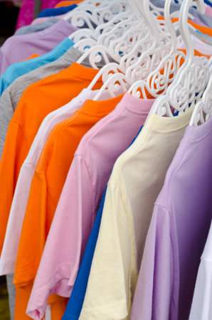 Colorful t-shirt on hangers