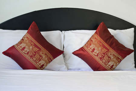 Traditional Thai style elephant pattern pillows on bedの写真素材