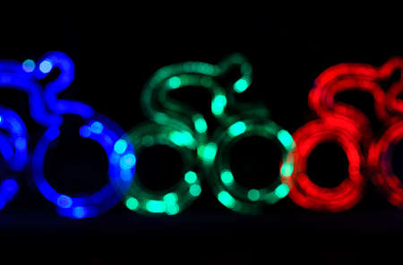 colorful cyclist shape bokeh lightsの写真素材