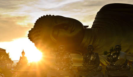 Silhouette of big Buddha statue over sunrise at Songkhla, Thailandの写真素材