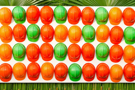 Row of grren and orange construction helmetsの写真素材