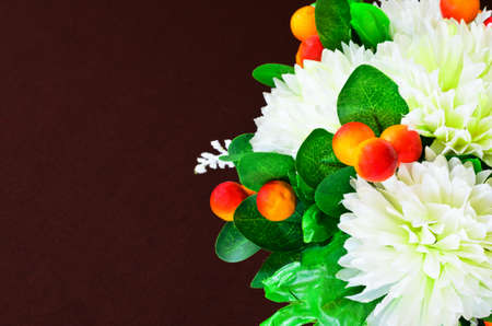 Artificial flowers decorative against brown backgroundの写真素材