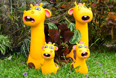 Funny giraffe clay dolls family decorated in gardenの写真素材