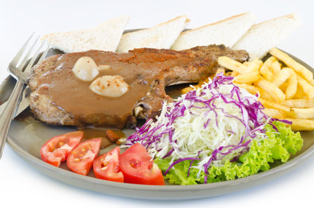 grilled steak with french fries and vegetable