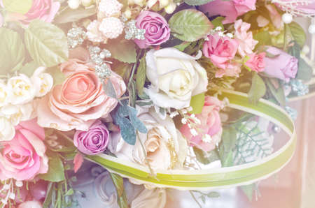 Soft focus artificial orange and white rose flowers bouquetの写真素材