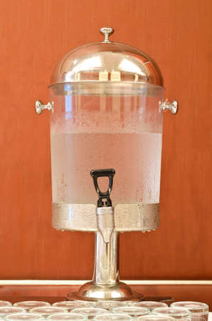 Water dispenser with glasses on reception tableの写真素材