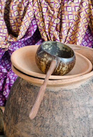Thai carved pottery drinking water pitcher and coconut shell ladle
