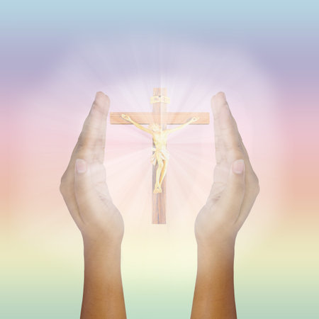 Prayer raised hands for glowing Jesus Christ on the Cross with