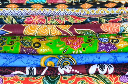 Colorful Printed fabric stack display in the cloths shopの写真素材