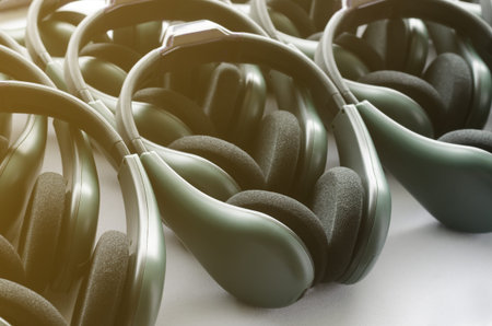 Dark green headphones stack on white table