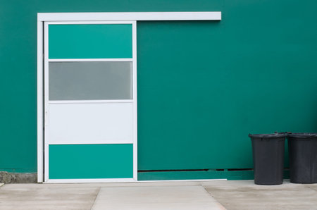 Deposit sliding door against green wall