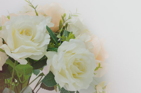Soft focus artificial white and orange rose flowers bouquet