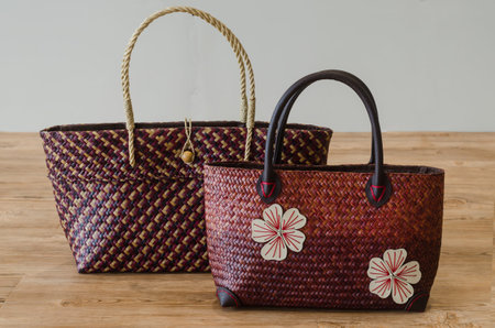 Hand woven Bags  from Krajood, a kind of sea grass on wood background