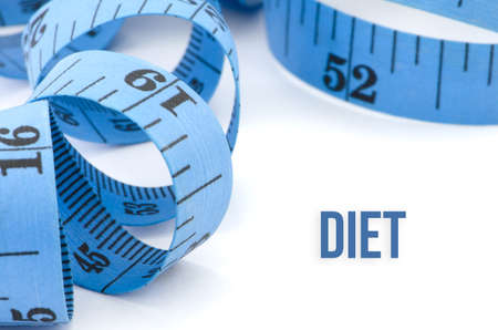 Diet, health concept, close up & selective focus of blue measuring tape, isolated on white backgroundの写真素材