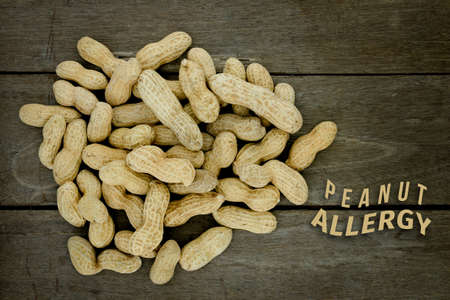 Peanut or groundnut food allergy health concept, close up on wooden backgroundの写真素材