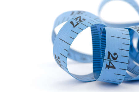 Close up of blue measuring tape for health concept, isolated on white backgroundの写真素材