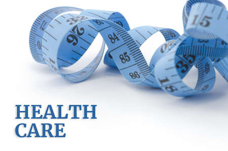Health care, health concept, close up & selective focus of blue measuring tape, isolated on white backgroundの写真素材