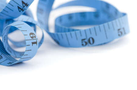 Close up of blue measuring tape for health concept, isolated on white backgroundの写真素材