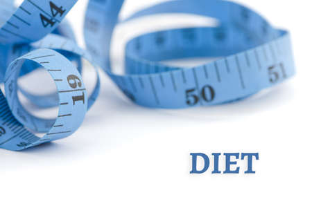 Diet, health concept, close up & selective focus of blue measuring tape, isolated on white backgroundの写真素材