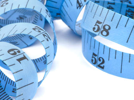 Close up of blue measuring tape for health concept, isolated on white backgroundの写真素材